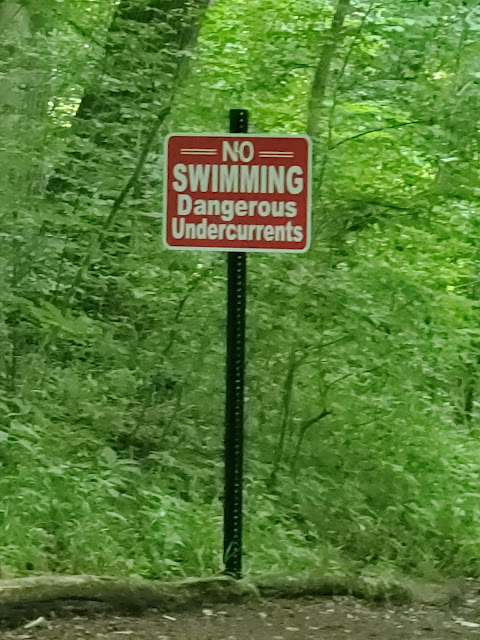 No swimming sign near the river at the Honey Run Waterfall Park