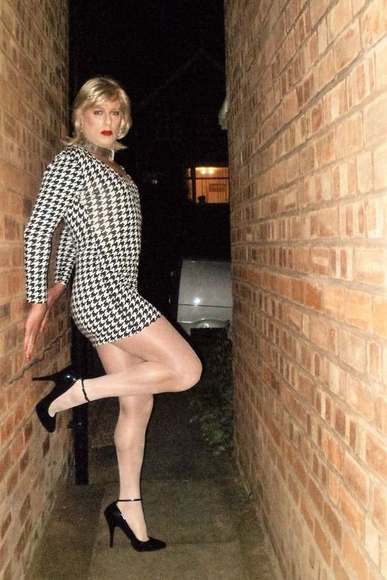 Hot crossdresser in mini dress, pantyhose and ankle strap high heels