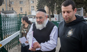 Police escort Rabbi Aharon Ramati for court hearing