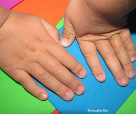 child's hands against color, shapes
