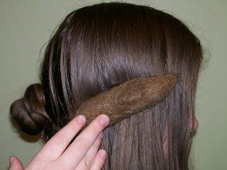 Frizette or rat positioned over the side hair.