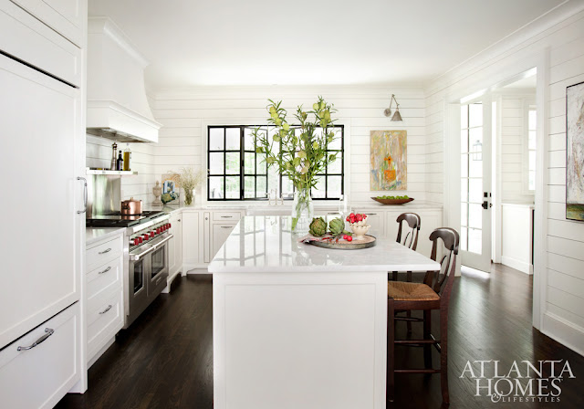 Showstopping white kitchen with shiplap, modern art, and black accents