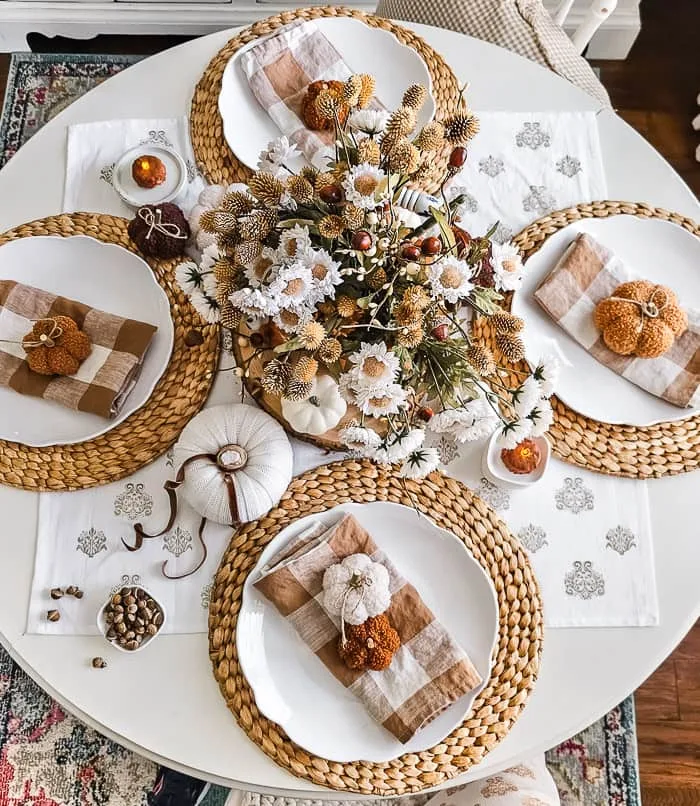 overhead shot Fall table, brown plaid napkins, pumpkins, copper, florals, candles