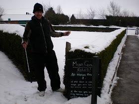 Minigolfer Richard Gottfried attempting to play on the snowed under Crazy Golf course at Tea Green Golf, Wandon End, Luton