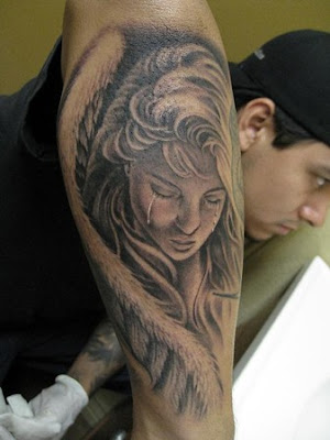 Crying angel tattoo on forearm