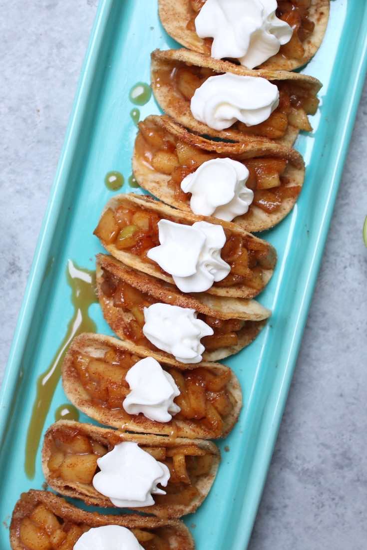 This.Is.Awesome. I can’t wait to tell you about these BAKED Apple Pie Tacos! Think cinnamon sugary apple filling in a crispy and sweet taco, drizzled with caramel sauce, and then topped with whipped cream!