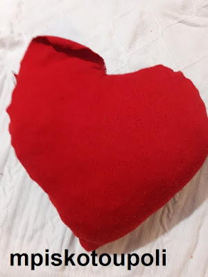 A HEART PILLOW WITH POM POM