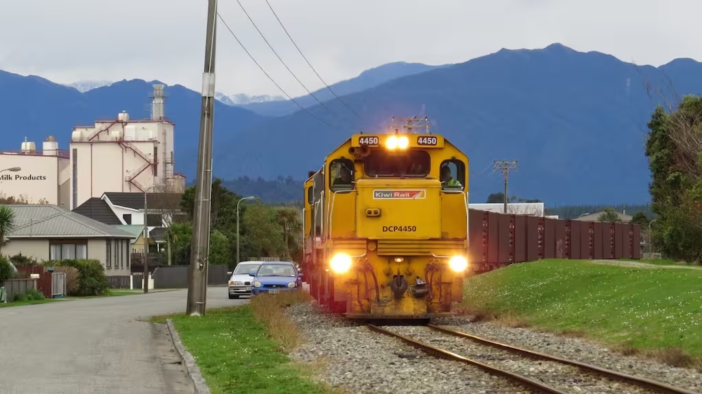 Một tuyến đường sắt Kiwi Rail* rời khỏi từ nhà máy chuyên sản xuất và phân phối các sản phẩm từ sữa Westland tại Hokitika. Đê bảo vệ khỏi lũ lụt theo kế hoạch sẽ ở bên phải của tấm hình. (Nguồn: Báo cáo Dân chủ Địa phương- Local Democracy Reporting)