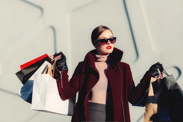 women carrying lots of shopping bags after a big spending spree