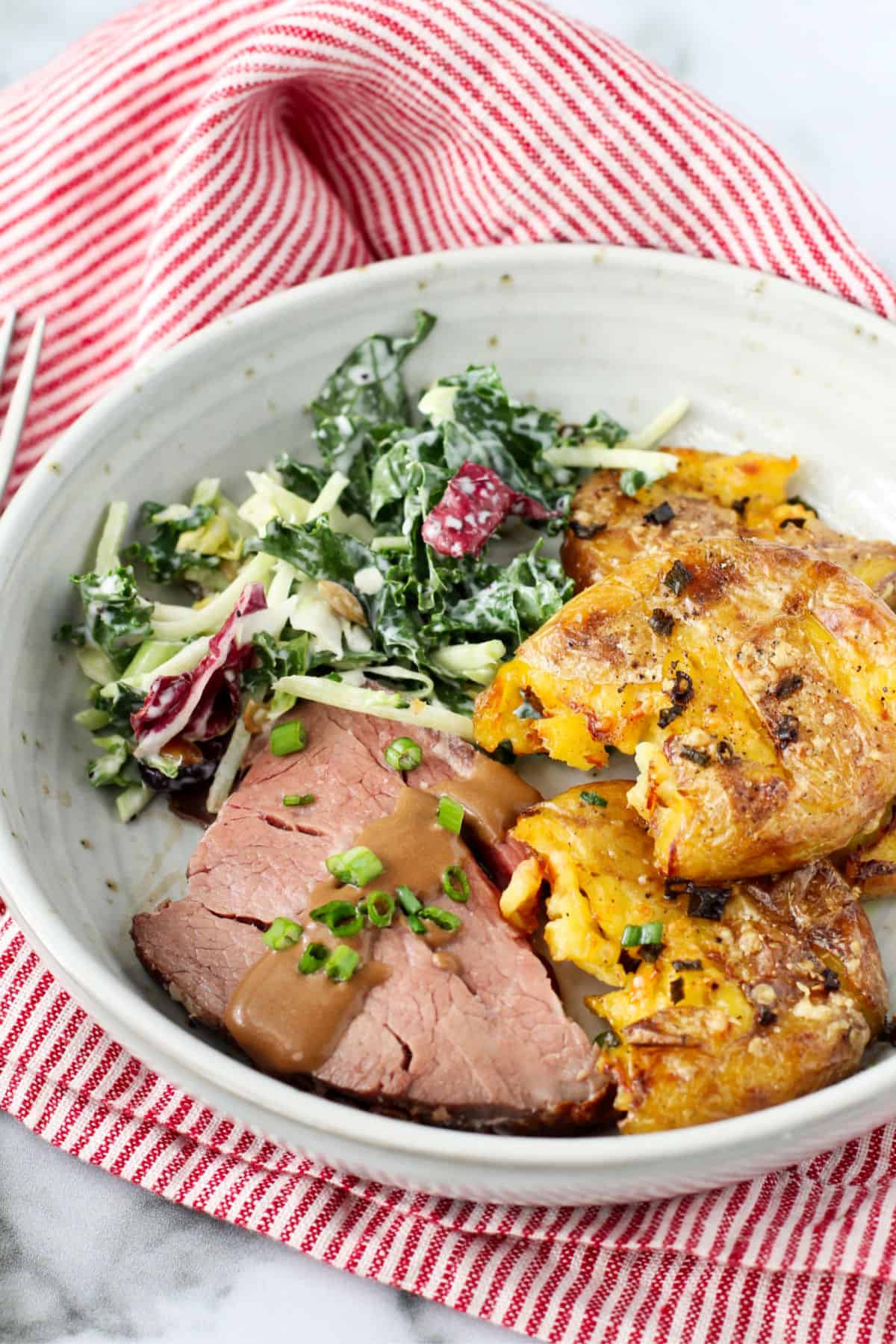 Beef Tenderloin with Red Wine Dijon Cream Sauce with salad and potatoes.