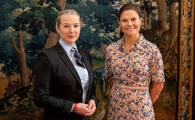 Crown Princess Victoria wore a floral print crepe dress by Arket. Ministerial Councilor Sigrún Rawet and Chancellor Karin Snellman