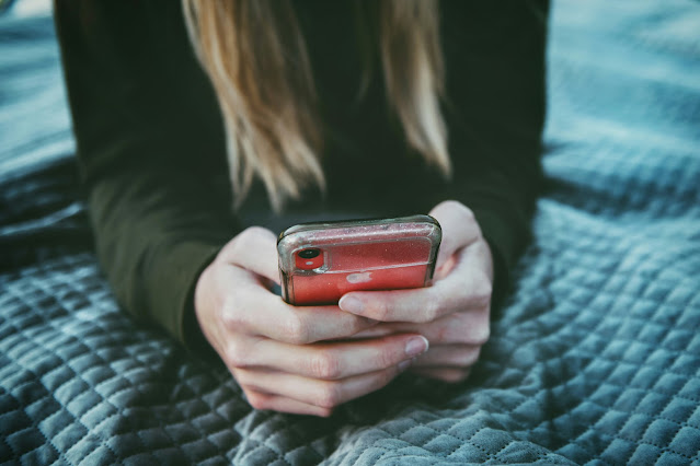 person looking at mobile phone screen:Photo by Tim Mossholder on Unsplash