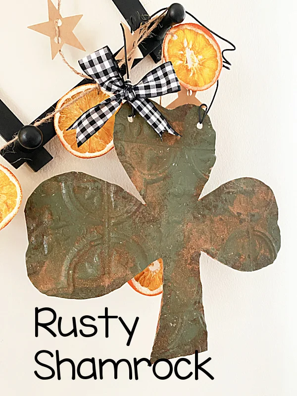 faux rusty shamrock on peg shelf with overlay