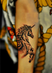 A unicorn tattoo on the arm