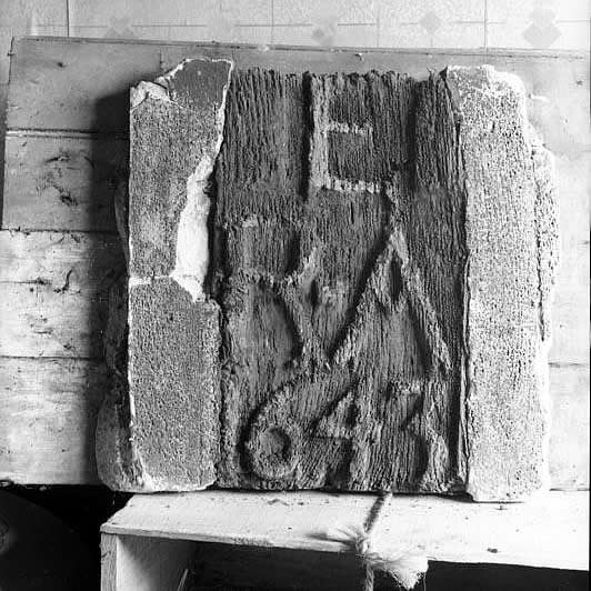 A carved oak panel bears the date 1643 and the initials R E A