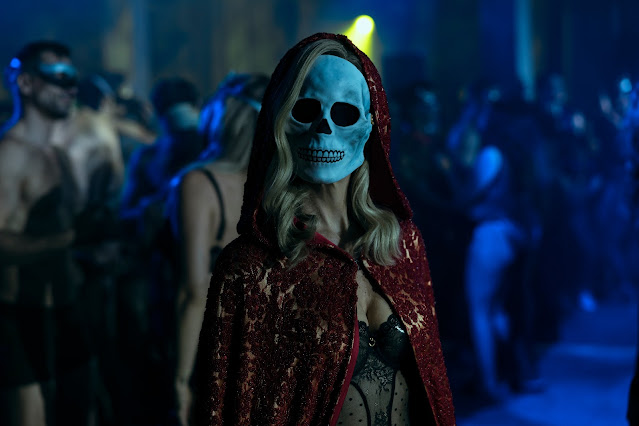 A woman wearing a masque at a party