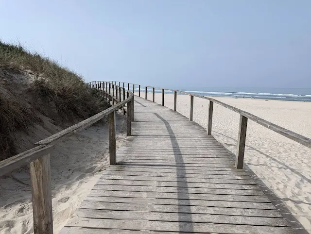 Boardwalk between beach and sand dunes near Farol da Barra