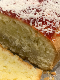 Jam and Coconut loaf cake with one slice cut