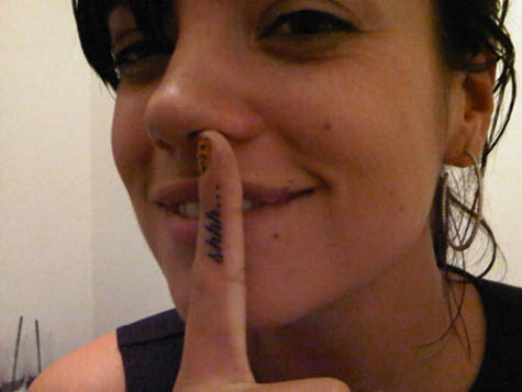 Also, she has the word "Shhh" tattooed on her index finger.