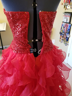 The back of the dress does not close on the dress form. It's being held on with binder clips.