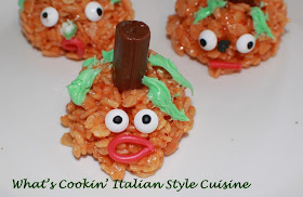 Halloween orange rice krispies pumpkin heads with tootsie rolls centers. These are a traditional recipe for rice krispie treats.