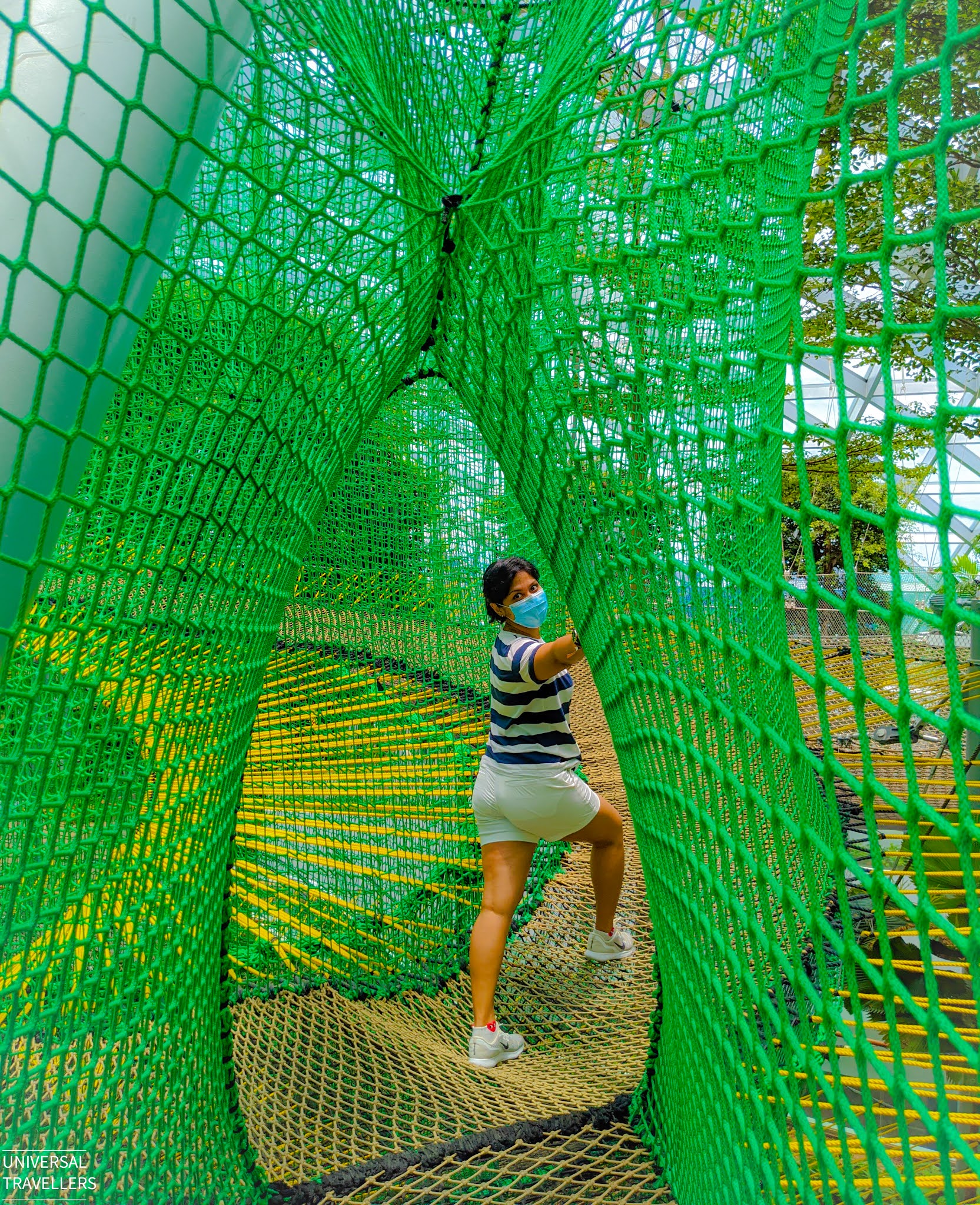 A girl is moving along the Manulife Bouncing Sky Net, located at level 5 inside the Jewel Changi Airport