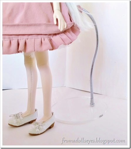 A peek at the invisible doll stand while in use.