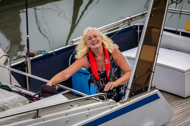 Photo of me reaching for my camera as we left the marina on Ravensdale. Photo by Ronnie Bell