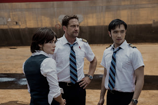 Daniella Pineda as Bonnie Lane, Gerard Butler as Brodie Torrance, and Yoson An as Samuel Dele in PLANE.