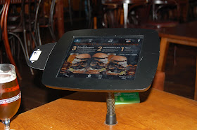 Enjoy a pint of Meantime Pale Ale while you peruse burgers on your inbuilt iPad 