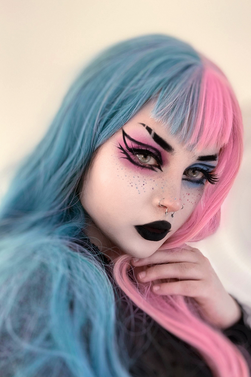 portrait of a young woman with blue and pink hair and a pastel goth makeup
