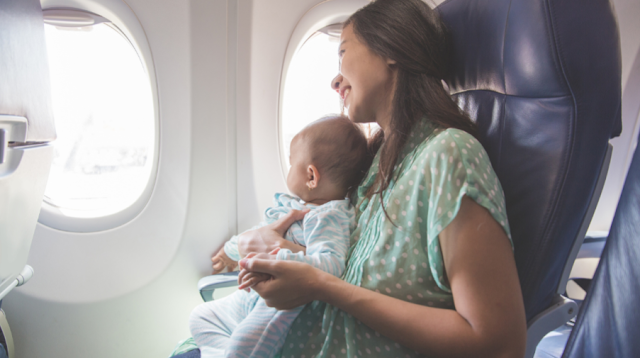 woman holding baby on plane