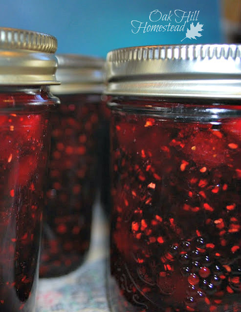 Three half-pint jars of triple berry jam