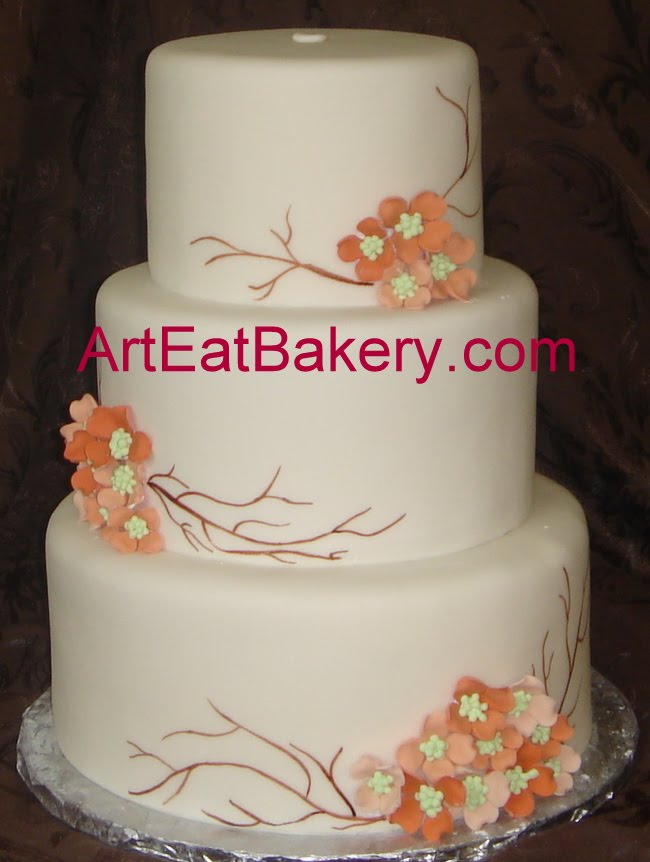 Three tier round fondant wedding cake with custom peach and salmon dogwood