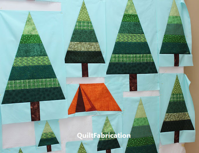 green striped trees on aqua background with an orange tent by QuiltFabrication