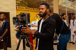 a man standing behind a camera
