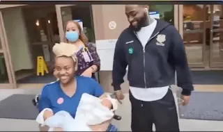 chioma with carry her twin baby with davido smiling