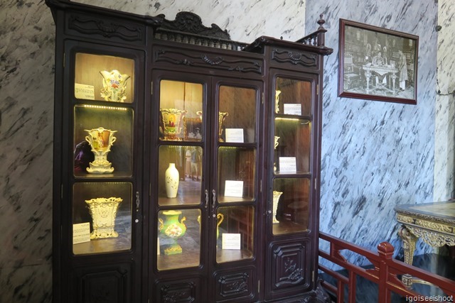 Cabinet showcasing many curios at Thien Dinh Palace. Tomb of Khai Dinh.