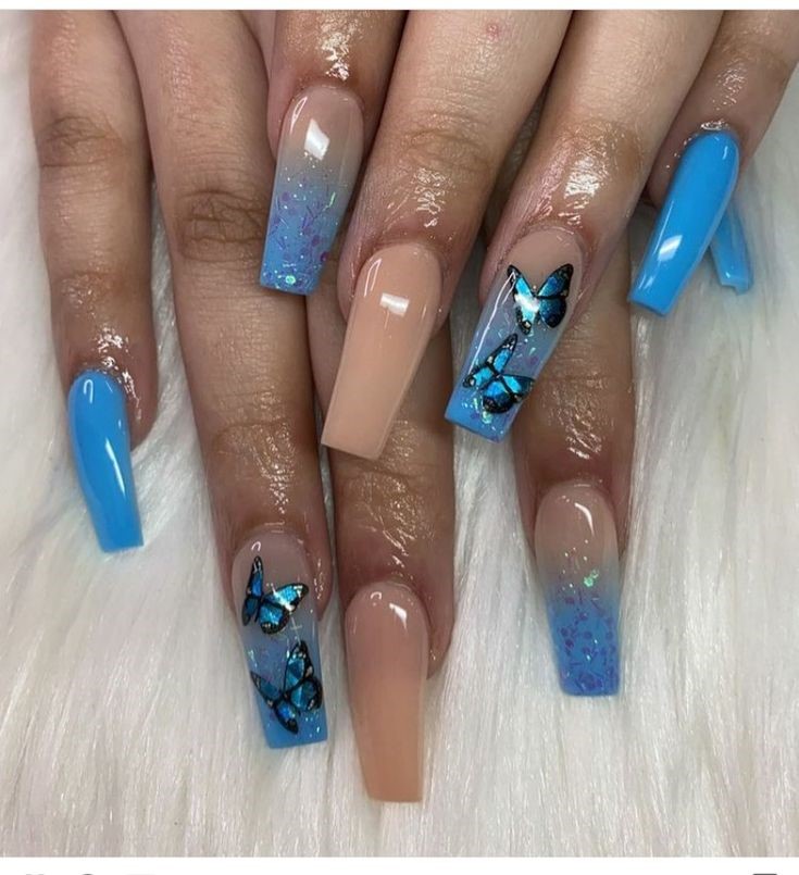 blue nails with butterfly nail art