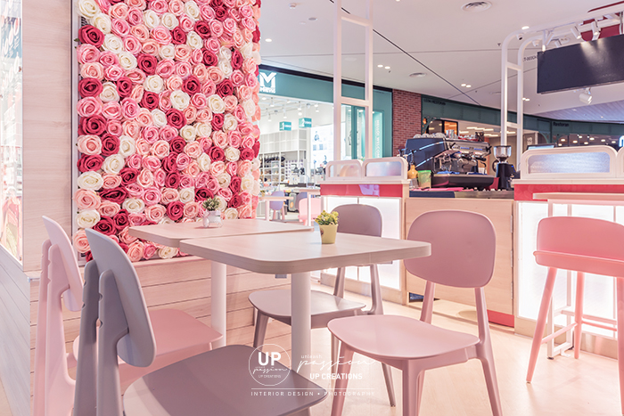 Central i city vanilla mille crepe kiosk highlighted area with floral, led neon signage and pastel color seating area