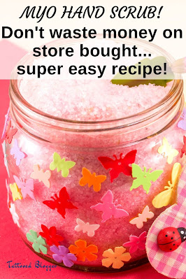 Homemade pink hand scrub in a small glass jar with paper butterflies on it