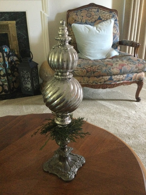 Silver candlestick with decorative ornament in it