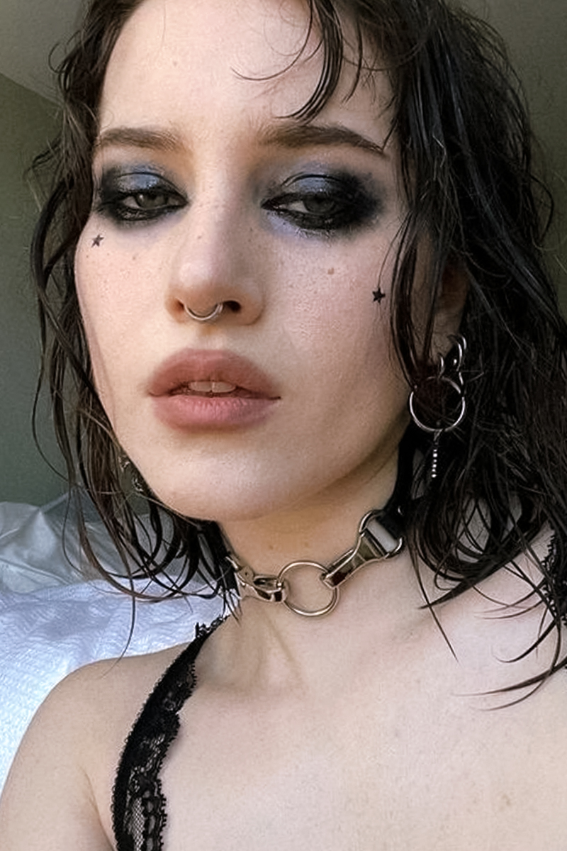 selfie of a beautiful woman with an edgy, punk makeup look and punk hairstyle