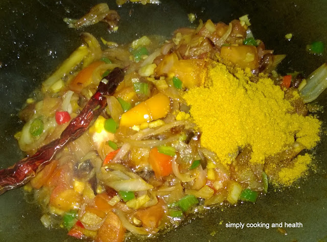 Adding curry powder and briyani spice powder