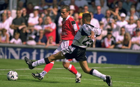 10 Sep 2000 Fabrice Fernandez (#25) of Fulham attempts to challenge Mitch Ward of Barnsley during the Nationwide League Division One match at Craven Cottage in London.