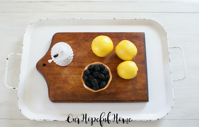 cutting board two handled white tray lemons blackberries