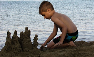Child building sand castle