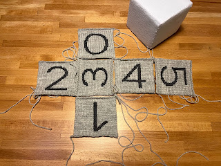 gray knitted milestone blocks number pieces being seamed together