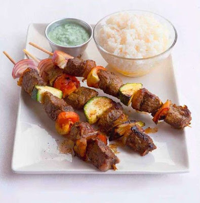 Beef souvlaki with tzatziki sauce and buttered rice