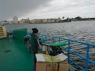 Aim'jie and bicycles on the ferry on the river.